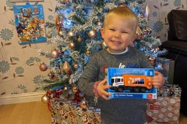 Ollie McEwan, 2,  from Falkirk with his gift of a toy bin lorry from the crew which he waves to every day