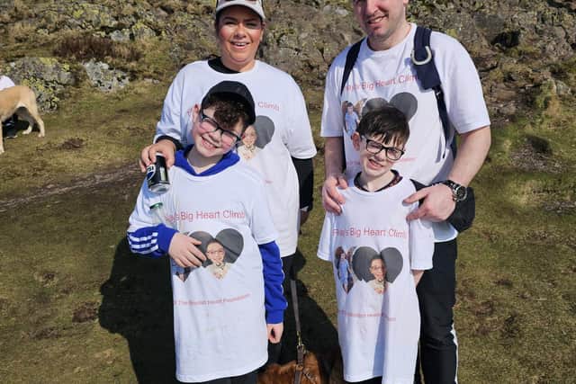 Finlay Wilson, 8, with mum Gayle, dad Steven and big brother Callan as they climbed Dumyat on Sunday to mark three years since Finlay's open heart surgery.  (Pic: submitted)