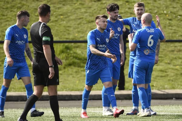 Ryan Porteous is mobbed by his Bo’ness team-mates after scoring from the penalty spot (Photo: Alan Murray)