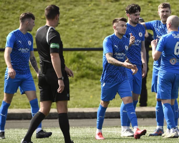 Ryan Porteous is mobbed by his Bo’ness team-mates after scoring from the penalty spot (Photo: Alan Murray)