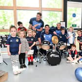 Falkirk FC footballers Tom Lang, Liam Henderson and Coll Donaldson attend the Larbert childcare centre ahead of trophy day.
