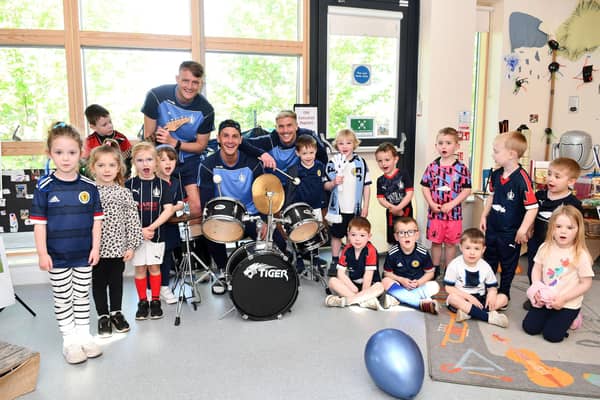 Falkirk FC footballers Tom Lang, Liam Henderson and Coll Donaldson attend the Larbert childcare centre ahead of trophy day.