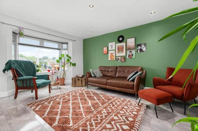 Living area is flooded with light, thanks to a broad window to the front and double French doors leading out to the garden.