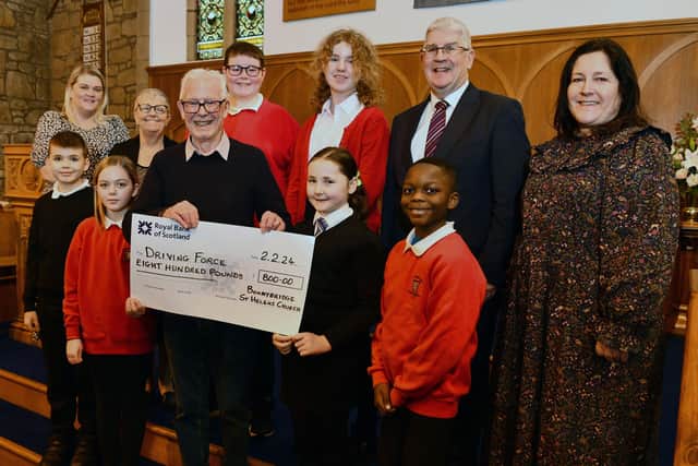 Driving Force receive a cheque for £800 after the Candlelight concert in December. Pic: Michael Gillen
