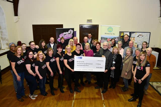 Bo'ness Belles hand over cheque for £5709.06 to Bo’ness Car 4U. Holding the cheque, Jeni Mallace, founder of Bo'ness Belles, and Rod McNeill, chair pf Bo’ness Car 4U