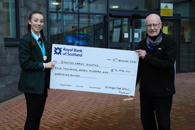 Dennis Canavan and St Mungo's High School pupil Caitlin Christie with a cheque for £4796 in aid of Strathcarron Hospice. Picture: Michael Gillen.