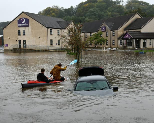 Cousins Thomas Grozier, of Bainsford, and Ben Brown, of Whitecross, kayaking in the Brewers Fayre car park at Polmont. Pic: Michael Gillen