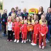 Youngsters and adult volunteers from Carron Division Girlguiding fundraised for a defibrillator which has been installed in the First Down public house in Dunipace. Pic: Michael Gillen