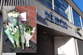 Flowers have been placed outside the entrance to the store.