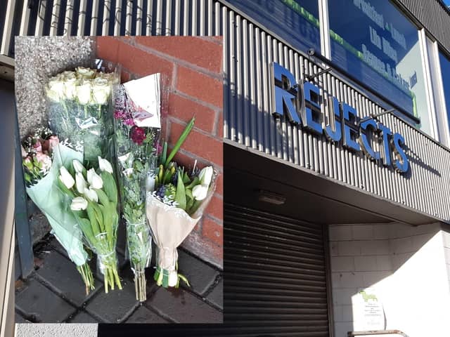 Flowers have been placed outside the entrance to the store.
