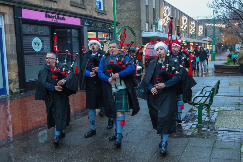 The pipes of Camelon and District Pipe Band ring out a festive tune or two for folk in Grangemouth town centre
(Picture: Scott Louden, National World)