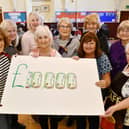 Polmont Snowdrop Community Cafe volunteers mark two years and £10,000 donated to charity: left to right, Helen Watson, Louisa McGrandles, Anna Rodden, Janice Morrison, Liz Graham, Rona Wearing, Alice Cumming, Grace Brown and Rosemary Taylor. Pic: Michael Gillen