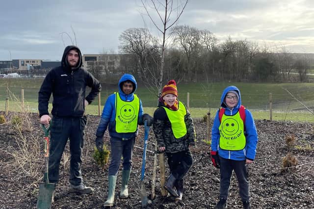 Pupils at Holy Family RC Primary School planting trees in Winchburgh.