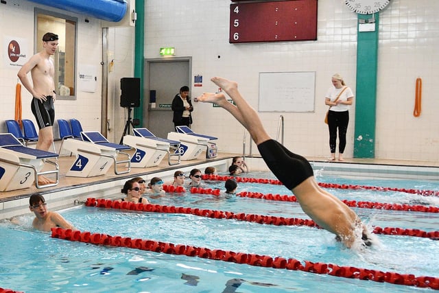 Swimmers enter the water.