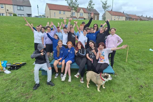 Youngsters with the new bench in Easter Carmuirs park. Pic: Contributed