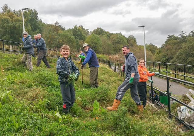 Stock photo of Burgh Beautiful hit squads out helping to create the spread of wild flowers at the cycle ramp between union canal and the leisure centre.