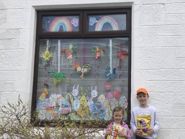 St Francis Primary School pupils Hannah (6) and Oliver Watson  (11) show off just some of the goodies they won for their Easter window display