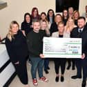 RSM staff hand over a cheque for £14,890 to Samantha Merrilees, who accepted the kind donation on behalf of the Scott Martin Foundation (Picture: Michael Gillen, National World)