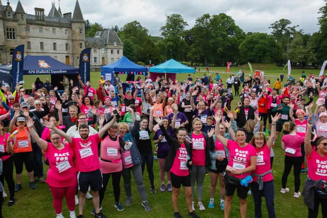 Race For Life entrants take part in the warm up on Sunday against a backdrop of Callendar House
