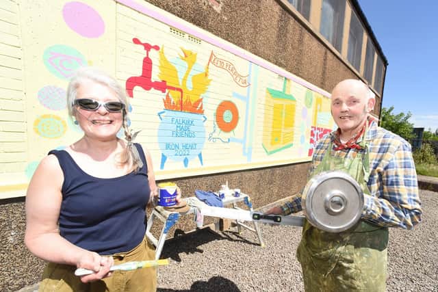 Rowena Comrie and Duncan Comrie with the 'Ironheart 2022' mural. Falkirk Made Friends coined the name Ironheart as a way of uniting the iron achievements of the many iron townships of the Falkirk area.