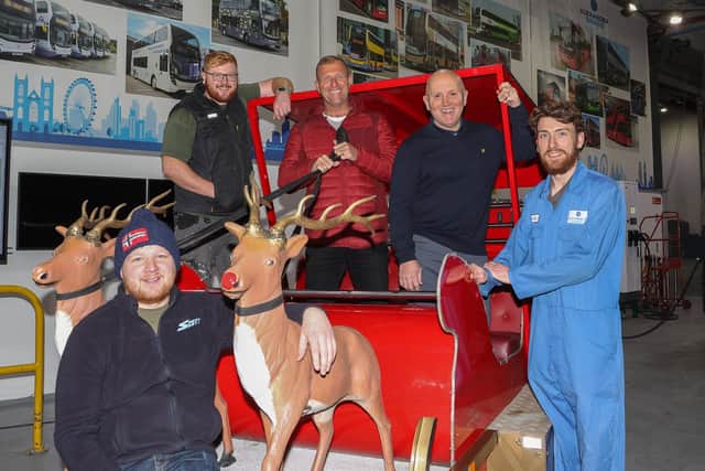 Santa's helpers from Falkirk Round Table (from left) Chris Scott, Jamie Sime and Kevin Beattie pick up the renovated sleigh from Robert Lapsley and Zane Parley of Alexander Dennis.   Pic: Scott Louden.