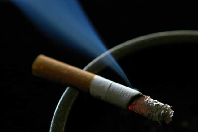 A cigarette burning on an ash tray. Pic:  Gareth Fuller/PA.