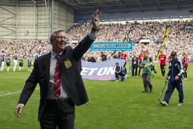 Manchester United's Scottish manager Alex Ferguson waves to fans before the start of the English Premier League football match between West Bromwich Albion and Manchester United, his last game before retirement, at The Hawthorns in West Bromwich, central England, on May 19, 2013. English football witnessed the end of an era as Alex Ferguson signed off as Manchester United manager with an extraordinary 5-5 draw at West Bromwich Albion in his 1,500th and final game. (Photo credit should read ADRIAN DENNIS/AFP via Getty Images)