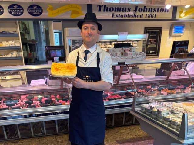 A member of the Thomas Johnston team with the winning steak pie. Pic: Contributed