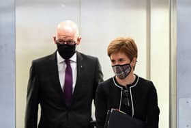 Scotland's First Minister Nicola Sturgeon (R) arrives with deputy First Minister John Swinney to attend First Minister's Questions at the Scottish Parliament in Edinburgh, Scotland on October 1, 2020. (Photo by Andy Buchanan / POOL / AFP)