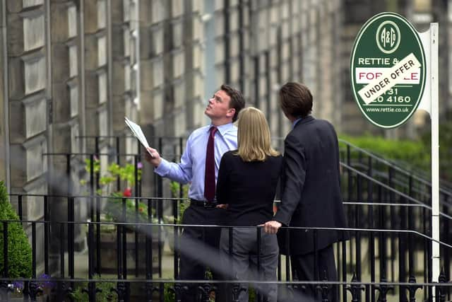 Estate agent showing a property (picture taken before current restrictions).