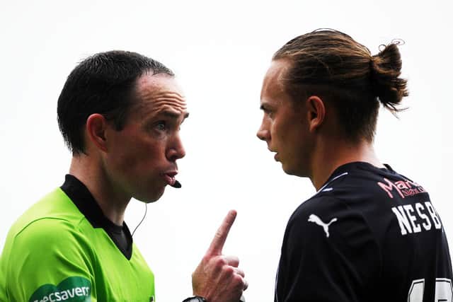 Nesbitt is spoken to by referee Colin Steven