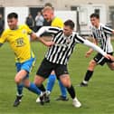 Dunipace's Jordan Herron looks to bomb forward past his St Andrews opponent (Photo: John Stevenson)