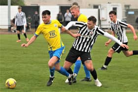 Dunipace's Jordan Herron looks to bomb forward past his St Andrews opponent (Photo: John Stevenson)