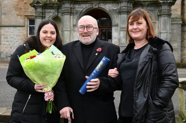Dennis Kerr with family when he received a Provost Award in 2021. Pic: Michael Gillen