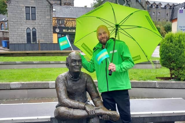 Michael Thompson at the end of the West Highland Way in Fort William with the Man with Sore Feet statue.. Pic: Contributed