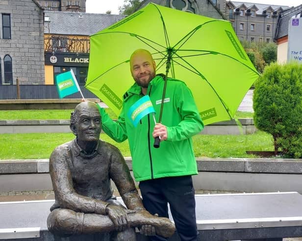 Michael Thompson at the end of the West Highland Way in Fort William with the Man with Sore Feet statue.. Pic: Contributed
