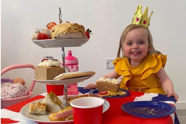 One-year-old Harley Rose Gibb from Falkirk has a fine time enjoying her Platinum Jubilee afternoon tea