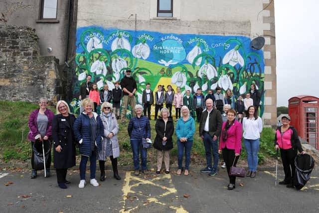 Strathcarron Hospice staff, including Irene McKie CEO (pink jacket and scarf), P4 and P5 pupils from St Patrick's RC Primary School, Councillor Paul Garner and artist Scott Gilbert proudly stand next to the new mural. Picture: Michael Gillen.