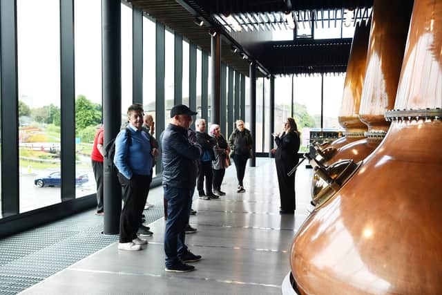 Guide Claire tells visitors about the new whisky stills - a replica of the ones used previously which mysteriously disappeared. Pic: Michael