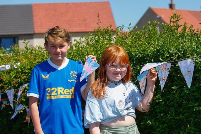 Owen, 11, and Elise, 8, with bunting made by local children