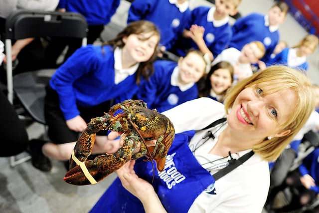 Marie-Clare James showing pupils a lobster.