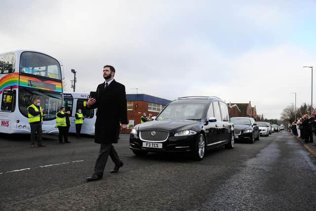 First Bus Larbert staff applauded as the funeral cortege of bus driver Thomas Rooney paused at the depot. Picture: Michael Gillen.
