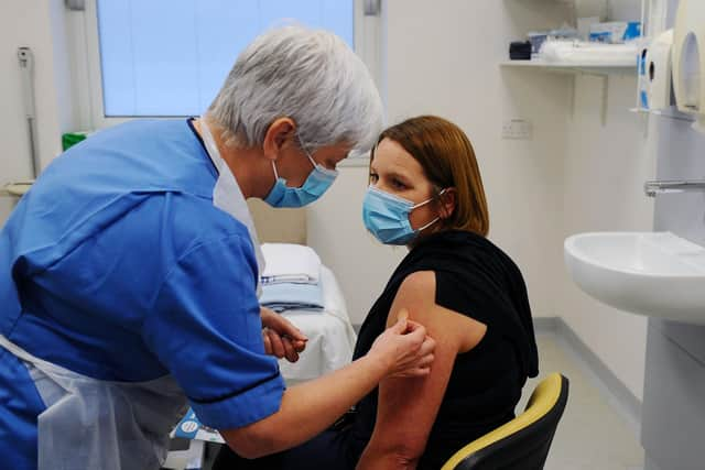 Dorothy Bell, Head of Occupational Health gives the vaccine to Hilary Nelson, ICU critical care nurse (Pic: Michael Gillen)