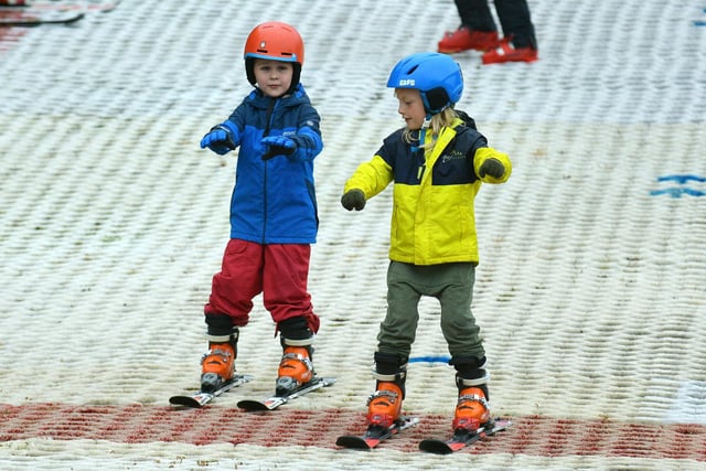 Two youngsters try out skiing at Polmonthill Snowsports Centre on Sunday.