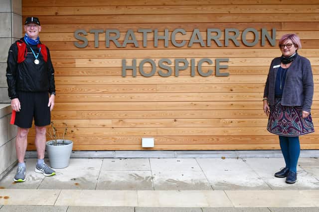 Runner Robert Myler, pictured with Strathcarron Hospice’s fundraising manager Jackie Johnston, clocked up 500 kilometres to generate cash for the service. Picture: Michael Gillen.
