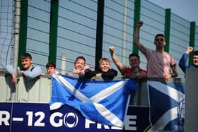 Falkirk fans, still not allowed in to the stadium due to the ongoing restrictions, watch from over the wall