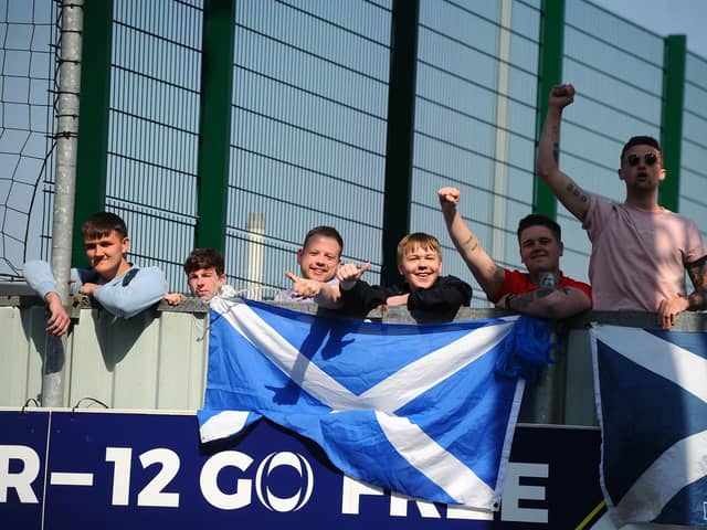 Falkirk fans, still not allowed in to the stadium due to the ongoing restrictions, watch from over the wall