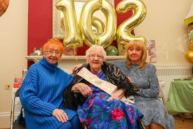 Birthday girl Mary is joined by her daughters Esther and Claire at the party in Thorntree Mews Care Home.(Picture: Scott Louden, National World)"