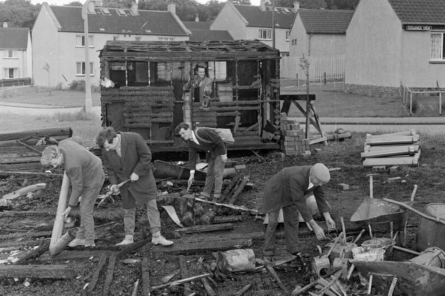 Workmen clear up debris after an explosion in a hut at Oxgangs Bank in June 1965.