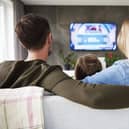A family enjoy TV together.